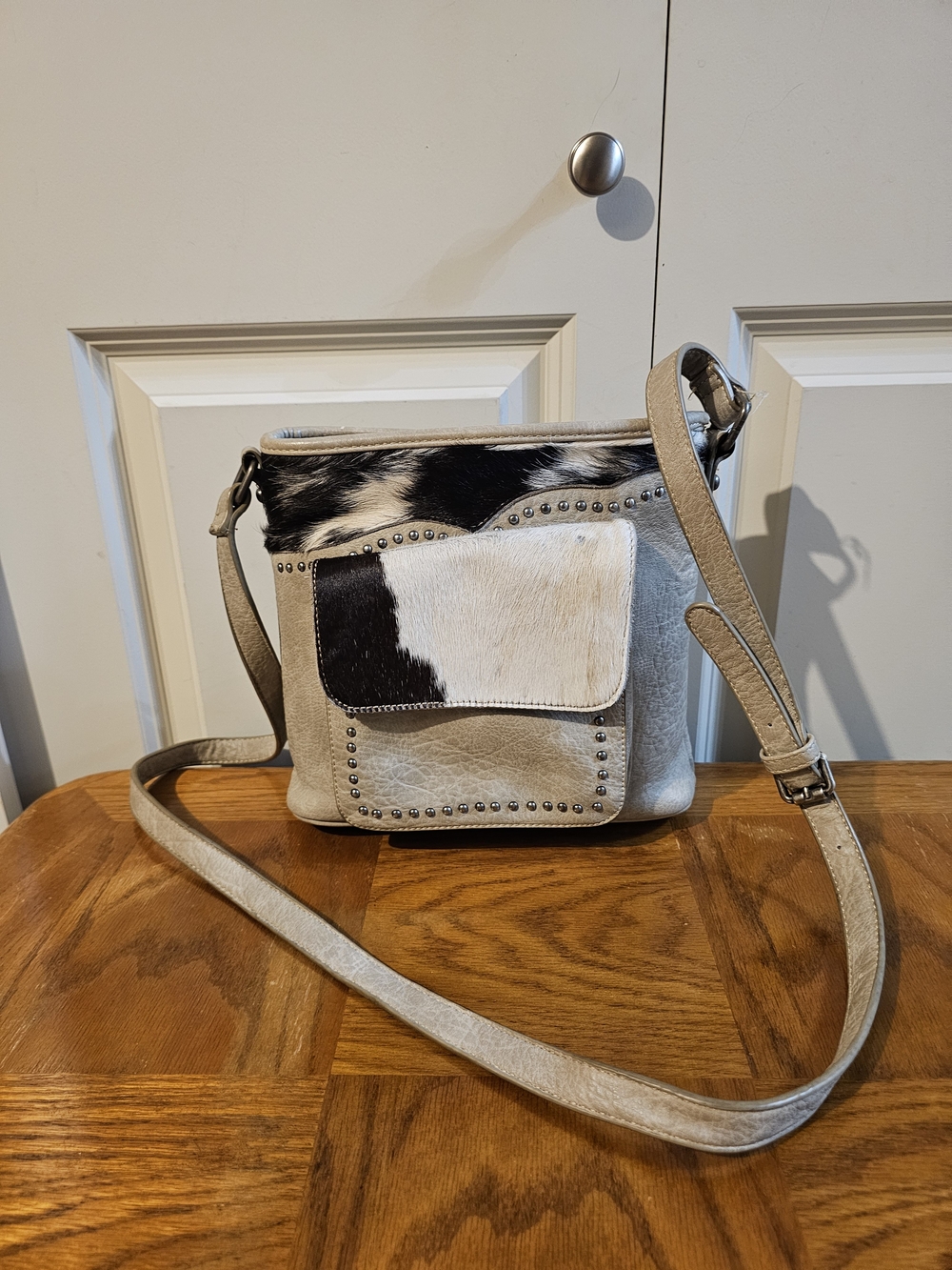 Trinity RANCH Beige and Black Cowhide Accent Crossbody Bag with Stud Detail
